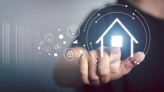 Smart home technology concept interface of smart home automation assistant and a user touching a button app screen with augmented connected objects in the apartment interior, person holding device. - Powered by Adobe