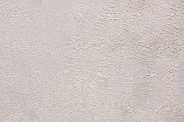 Beige background of the plastered wall. Close up.