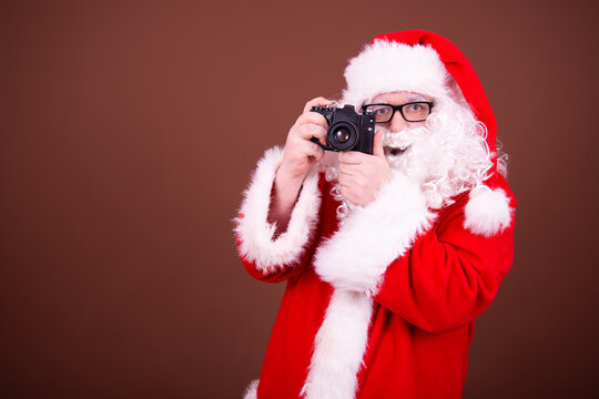 Funny santa claus takes pictures.