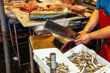cook on fish kitchen , lifestyle of a marine restaurant worker closeup