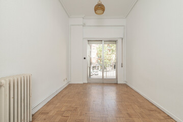 Fototapeta premium Empty living room with oak parquet and exit to a terrace through an aluminum window with sliding leaves