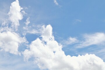 The fluffy cloud in the light blue sky in sunny day. 