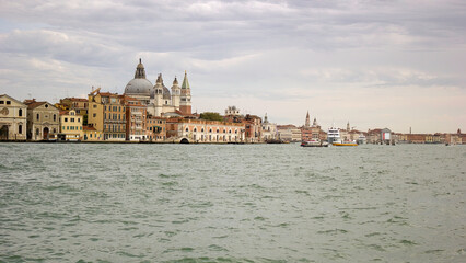 Fototapeta na wymiar Venice, Italy: Panorama wide angle shot of a city view showing few famous building such as Basilica di san Giorgio Maggiore and doge church from behind at St Mark s square