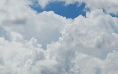 The fluffy cloud in the light blue sky in sunny day. 