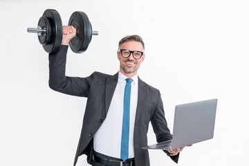 positive businessman in suit hold heavy dumbbell and laptop isolated on white background