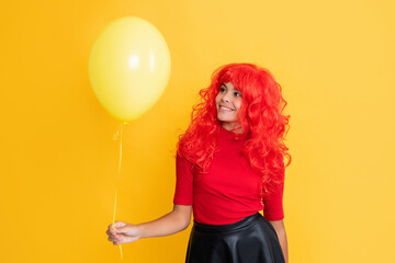 smiling girl with party balloon on yellow background