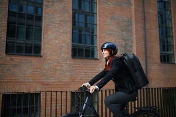 Businesswoman commuter on the way to work on bike, sustainable lifestyle concept.