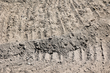 Sand grunge texture with traces of heavy equipment on a building site