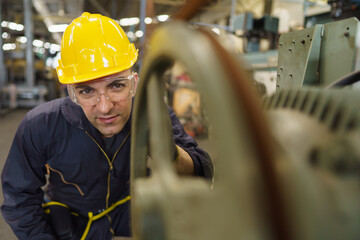 Portrait of optimistic industrial worker working at industrial site factory, concept manufacturing industry, engineering worker profession.