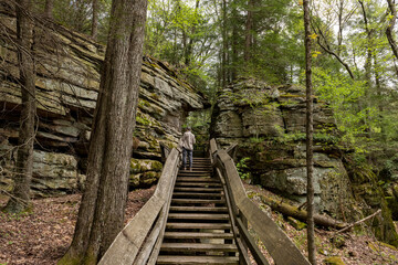 Visitor examining Droop sandstone rocks in Beartown State Park in West Virginia.