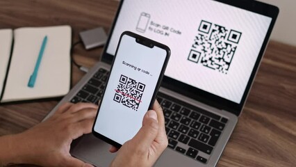 Log In Web Page Using Smartphone with QR Code Scanning Application. Authorization or Autentification with Bar Code Reader. Synchronously Successful Approval on Laptop and Mobile Phone. CloseUp VIew. - Powered by Adobe