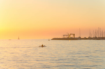 Fototapeta na wymiar Kayaking during sunset in the port of Umag.