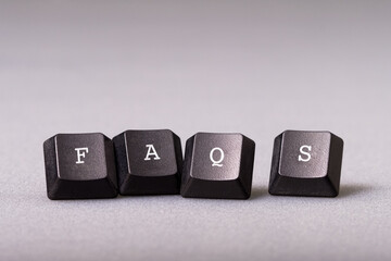 FAQs, Frequently Asked Questions, by a piece of computer keyboard - obrazy, fototapety, plakaty