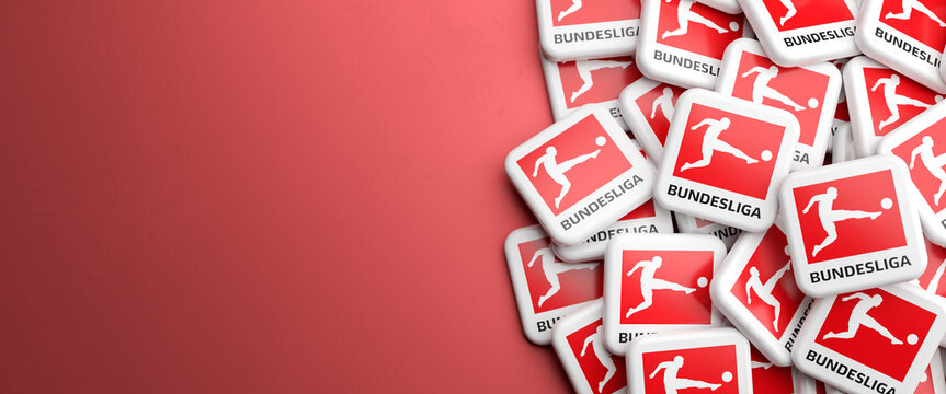 Logos of the German Soccer League Bundesliga on a heap on a table. Copy space. Web banner format