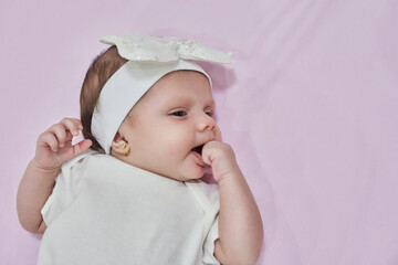 Baby Girl with white Flower Headband. 2-month-old baby girl.