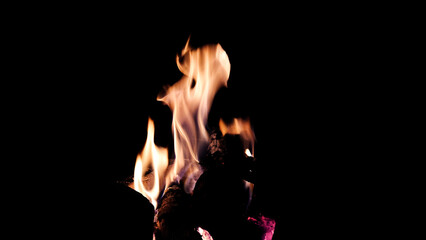 The hot embers of burning wood log fire isolated on black. Firewood burning on stove.