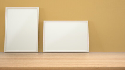 Frame mock up on wooden table, desk or shelf. Yellow plaster wall background with copy space, interior design template