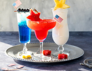 Celebratory 4th of July cocktails against a bright sunny window.