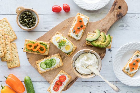 Everything crackers garnished with a variety of fresh spreads and toppings.
