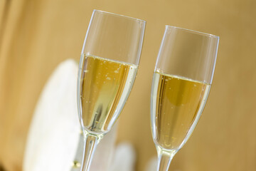 glasses with cava on a golden background