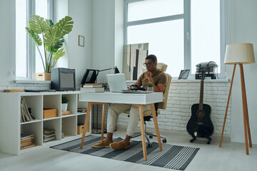 Concentrated young mixed race man working in office