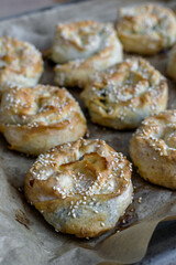 Twisted patties with dock and white cheese placed in the pan