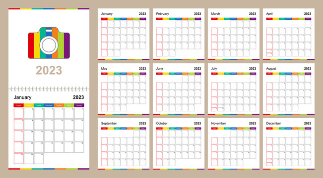 Colorful wall calendar for 2023 on beige background, week starts on Sunday.