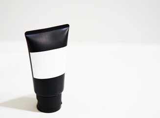 black cosmetic mockup cream tube on white with label