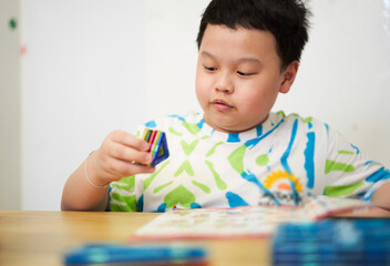 boy building a toy house be creative