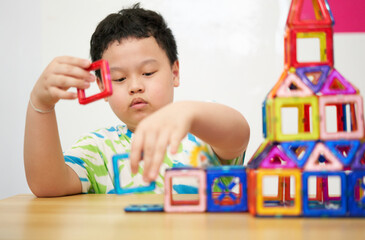 boy building a toy house be creative