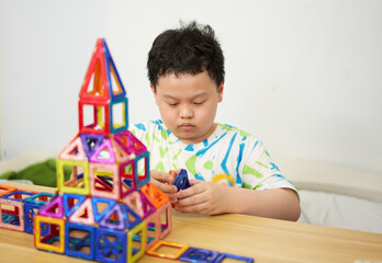 boy building a toy house be creative