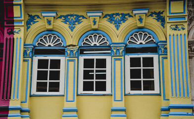 Colorful old house facades and ornate metal balconies