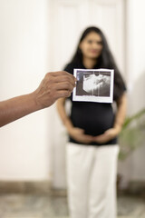 pregnant women sonogram with blurred background from flat angle