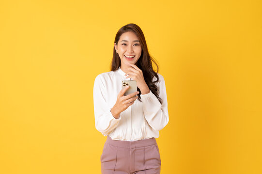 Smiling asian woman white shirt on yellow background
