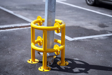 Metal protective fence around the electric line pole in the parking lot. Not to be broken