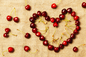 Cherry berries on fabric in the shape of a heart