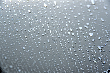Water drops on the white surface of the car