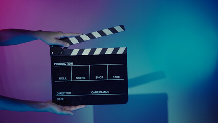 Movie Clapper board. Crew hand holding plastic and wooden film slate board against camera. Movie...