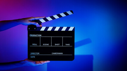 Movie Clapper board. Crew hand holding plastic and wooden film slate board against camera. Movie...