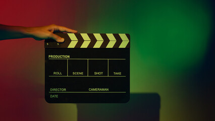 Movie Clapper board. Crew hand holding plastic and wooden film slate board against camera. Movie...