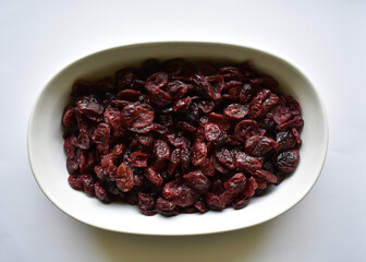 white dish with dried cranberries