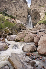 Landscape of mountain waterfall and rough river among the rock stones. Natural landscape.