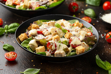 Vegetarian ceasar salad with meat free chicken pieces cherry tomatoes croutons and lettuce
