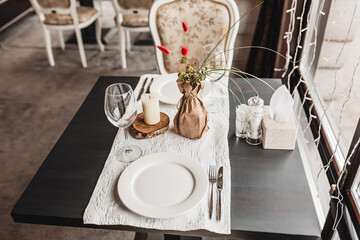 Luxury table setting for couples dining in a restaurant in pastel colors close up