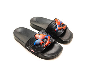 Obraz premium Pair of adilette shower slides sandal style with an open toe and print design of Spiderman from Adidas isolated on white background