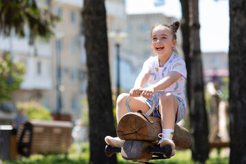 Adorable Little girl playing outdoor in park summertime