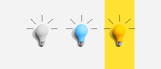 Idea and creativity concept with white, blue and yellow light bulbs - Flat lay