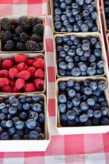red, blue and black berries at the market