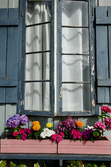 neglected house exterior with colorful flowers