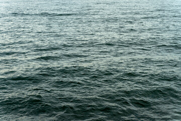 Cropped view of the small sea waves at the deep blue colour ocean